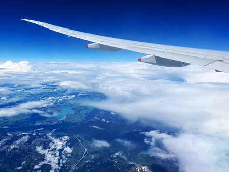 Aerial Perspective of German Countryside and Mountains with Airplane Wingの写真素材