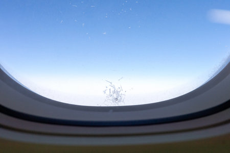 Ice Crystal Pattern on Airplane Window at High Altitudeの写真素材