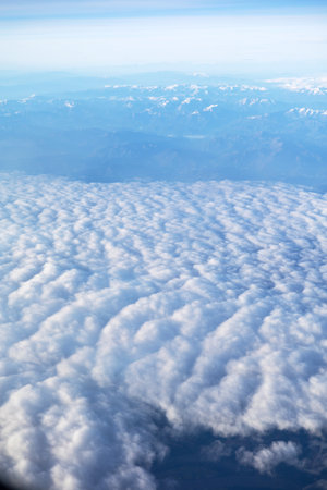 Majestic Mountain Range Above Dense Cloud Layerの写真素材