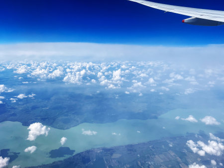 Aerial View of Landscape with Clouds and Plane Wingの写真素材