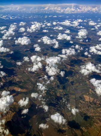 High-Altitude Aerial View of Farmland and Cloud Shadowsの写真素材