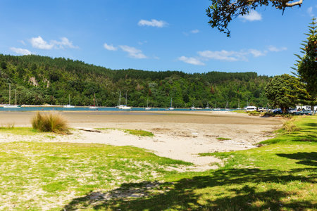 Scenic Coastal Landscape with Boats and Lush Hills in Whangamata, New Zealandの写真素材