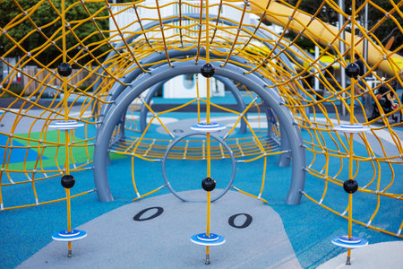 A close-up of the colorful climbing nets and play structures at Frank Kitts Park Playground in...