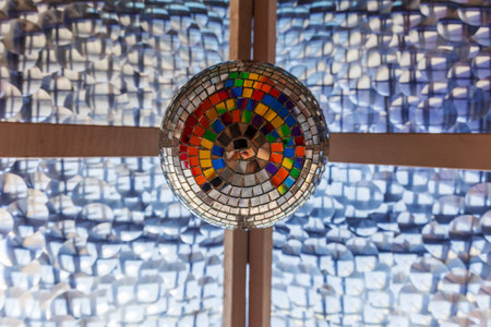 Vibrant Mosaic Disco Ball Under Textured Ceilingの写真素材