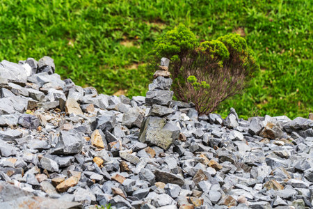 A carefully balanced stone cairn stands amidst a rocky slope