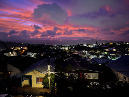 Vibrant Sunset Over Illuminated Hillside in Wellingtonの写真素材