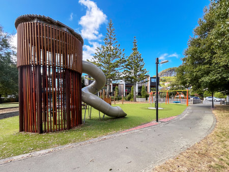 Modern Playground with Tower Slide and Swings in Urban Parkの写真素材