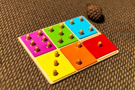 Colorful Wooden Peg Puzzle on Carpetの写真素材