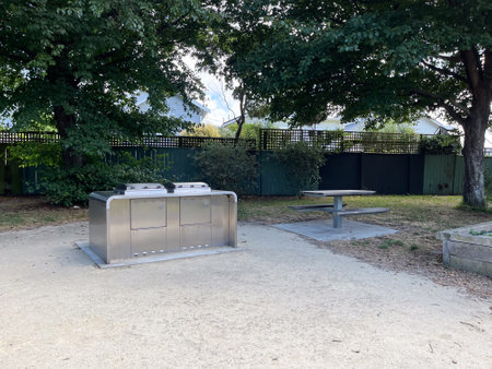A serene outdoor BBQ and picnic area at Carrara Park play area in Wellington, New Zealandの写真素材