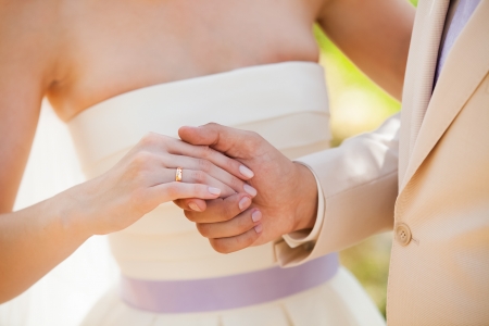Wedding photograph of a young couple of lovers who are just married, are close to each other in harmony, love and happiness  Groom holds the brideの写真素材