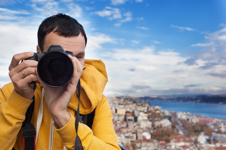 Tourist with a camera photographing landscape in Istanbul, Turkey  Landscape looked like a classic European city の写真素材