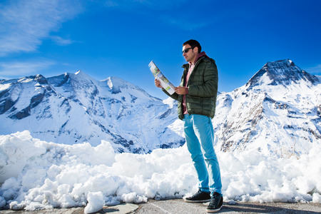 Tourist on the background of snowy mountainsの写真素材