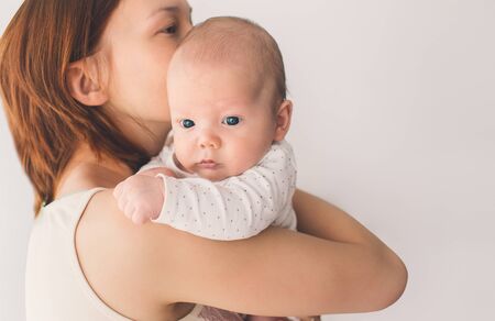 Close-up portrait of a tender mother and cute babyの写真素材