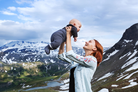 Baby and mother with the Alps mountains in nature in the Backgroundの写真素材