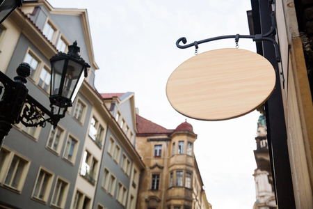 Empty wooden signboard on a european street. Architectural detail close-up ready for your textの写真素材