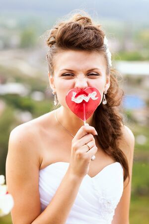 Portrait of Beautiful Happy Bride with Wedding Makeup and Wedding Hairstyle in Wedding Dress. Outdoorsの写真素材