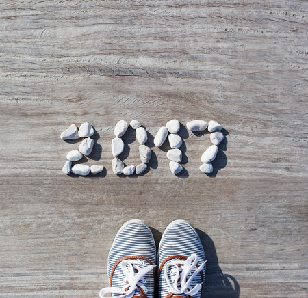 2017 laid out stones on a background wooden pier with shoes. The concept of the new year, holidays, travel, lifestyle, vacation, travel. Minimalism Styleの写真素材