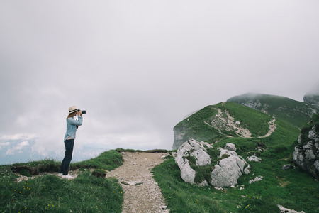 Traveler or hiker in the mountains. Mangart is a mountain in the Julian Alps, located between Italy and Slovenia. Travel, Freedom, Lifestyle concept.の写真素材