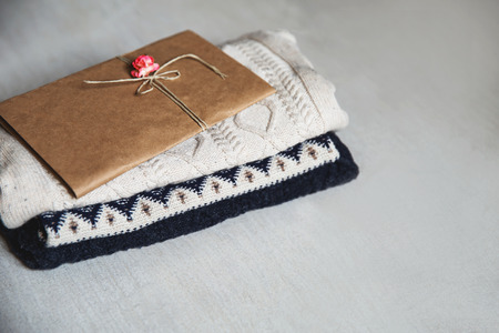 Autumn or winter baby clothes. Baby clothes and envelope. Waiting for the baby: preparing for congratulation.の写真素材