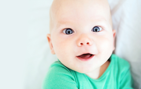 Portrait of a cheerful baby 6 months oldの写真素材