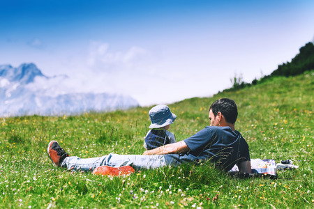 Father with son spends time on nature in the mountains. Family background. Lifestyle, Travel concept. Parent and child together. Velika Planina or Big Pasture Plateau in the Kamnik Alps, Slovenia.の写真素材