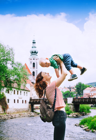Family of Tourists in Cesky Krumlov, Czech Republic. Mother and son walking near Vltava River. Springtime or Summer in Europe. Travel and Holidayの写真素材