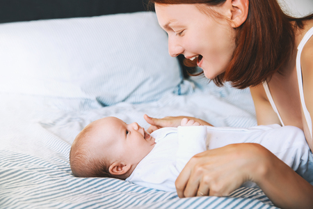 Mother and baby. Mom spend time with her little child at home. Image of happy maternity and family.の写真素材