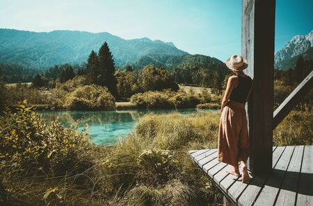 Young woman enjoying freedom on nature outdoors. Travel, Relaxation, Lifestyle Image. Amazing view on Zelenci (into English means - green) natural reserve in Slovenia, Europe. Nature background.の写真素材