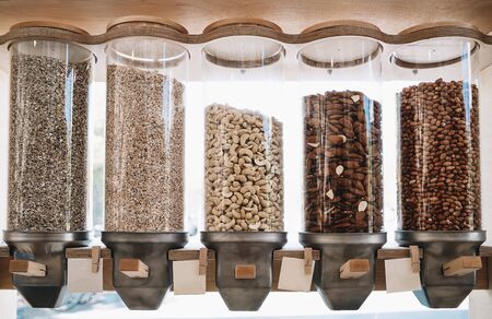 Eco-friendly zero waste shop. Dispensers for cereals, nuts and grains in sustainable plastic free grocery store. Bio organic food. Shopping at small local businesses. New trend alternative buyingの写真素材