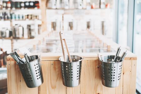 Zero waste shop interior details. Background with wooden shelves with refillable food containers in plastic free grocery store. Eco friendly shopping at local small businessesの写真素材