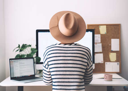 Woman working on computer at home office. Workplace, desk of creative worker. Modern remote work concept - self-employed freelancer, copywriter, designer. Distance education, student learning online.の写真素材