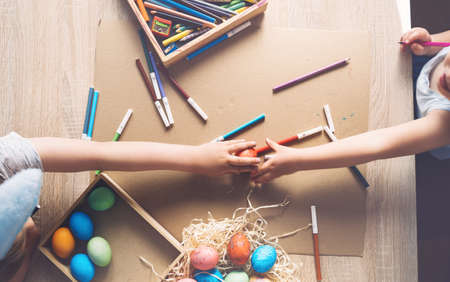Children prepare for easter. Kids painting easter eggs. Easter background, flat lay, top view.の写真素材
