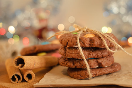 Cookies folded in a column and tied with cinnamon-flavored rope. Creative presentation in the store. Sweet pastries with candies for children. New Year background.の写真素材