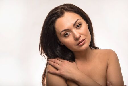 Beautiful woman with clear skin on the white backgroundの写真素材