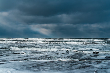 Winter landscape with frozen sea and icy beach. Dramatic seascape. Storm and snow weather.の写真素材