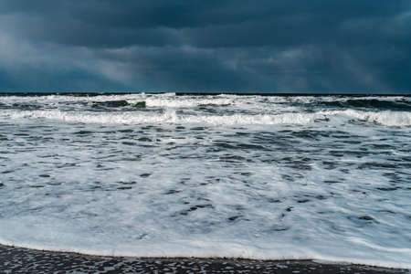 Winter landscape with frozen sea and icy beach. Dramatic seascape. Storm and snow weather.の写真素材