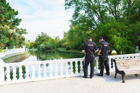 Sochi, Krasnodar Krai, Russia - June 06.2017: Two police officers follow the rule of law around the pond in the dendrological Park "Southern culture". Patch "Police"のeditorial素材