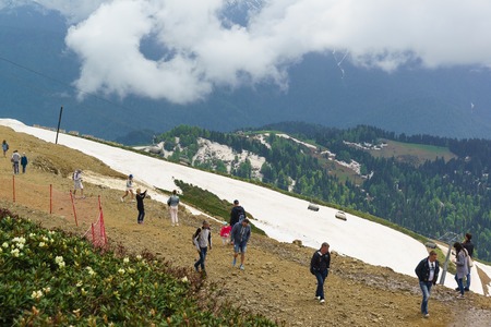 Estosadok, Sochi, Russia - June 10.2017: Tourists take pictures of mountain scenery in the ski resort "Rosa Khutor". On the slopes are remnants of snowのeditorial素材