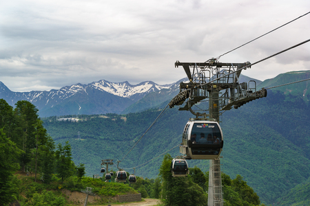 Estosadok, Sochi, Russia - June 10.2017: cabins ropeway ski resort "Rosa Khutor" mountain background, summer cloudy dayのeditorial素材