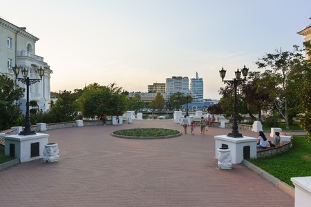 Russia, Crimea, Sevastopol - September 04.2017: Campers are sitting on benches in the evening in the Park on the waterfront of resort townのeditorial素材