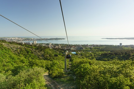 Russia, Gelendzhik, Krasnodar region - April 30.2017: Descent by cable car, Gelendzhik Safari Park with the Markotkh mountain range to the resort city. A warm spring eveningの写真素材