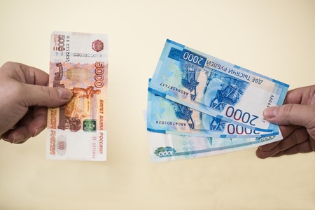 Equivalent exchange of five thousand Russian banknotes for smaller money in two and one thousand rublesの写真素材