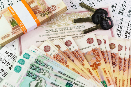 Inscription in Russian: Certificate of state registration of real estate. Documents and keys on a large sum of Russian money. Purchase of housingの写真素材