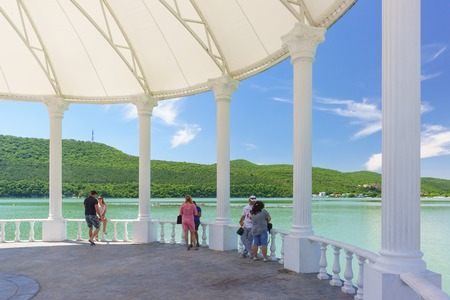 Russia, Krasnodar region, Novorossiysk, Abrau-Durso village - June 12, 2018: Vacationers on the waterfront of the picturesque mountain lake Abrau. Music sceneのeditorial素材