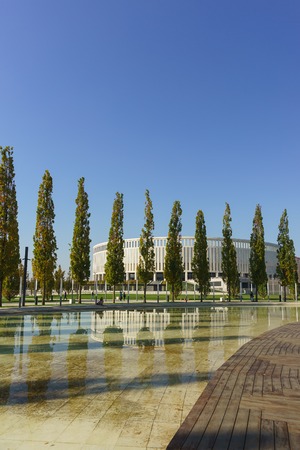 Krasnodar, Russia-October 19, 2018: Pyramidal poplars are reflected in the pond of the new city Park Krasnodar near the stadium of the football club of the same name. Sunny autumn dayのeditorial素材