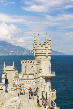 Russia, Crimea, Yalta, Gaspra-September 10, 2018: Tourists visiting the old Gothic castle swallow's Nest on the southern coast of Crimea. Picturesque turrets against the beautiful skyのeditorial素材
