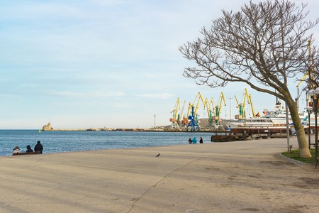 Feodosia, Crimea, Russia - March 08, 2019: Quay and port on the Black sea in Feodosia. Spring day. Off-seasonのeditorial素材