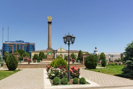 Grozny, Chechen, Russia - June 02, 2019: Flower alley and stele with the coat of arms of Russia in honor of awarding the city the title of "City of military glory" in front of the city hall of Groznyのeditorial素材