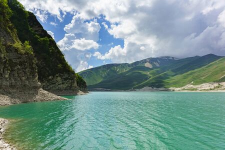 Highland lake Kazenoyam on the southern slope of the Andean mountain range is the largest lake by area of the Chechen Republic and the greater Caucasus. Sunny day in early summerの写真素材
