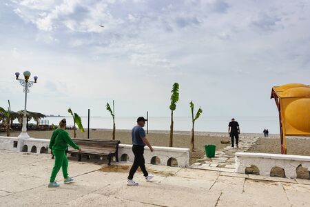 Gagra, Abkhazia - may 02, 2019: People are walking towards the sea in the seaside Park. Warm spring dayのeditorial素材